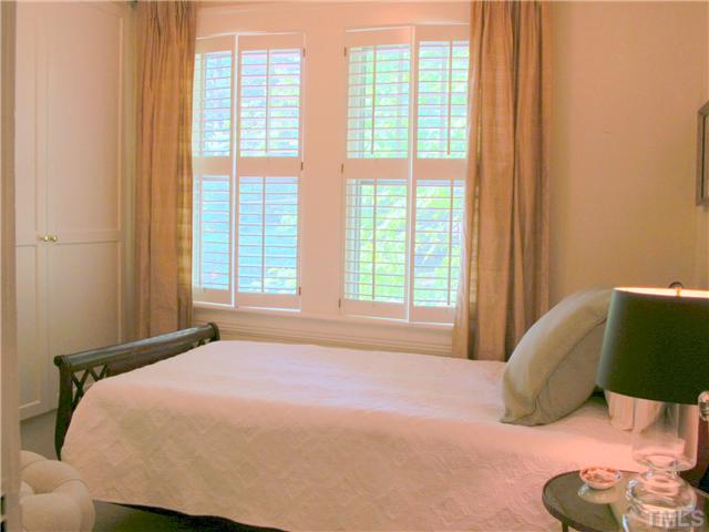 2238 The Circle Raleigh, NC 27608 - Photo 16 of 23 a bedroom with a bed and a large window