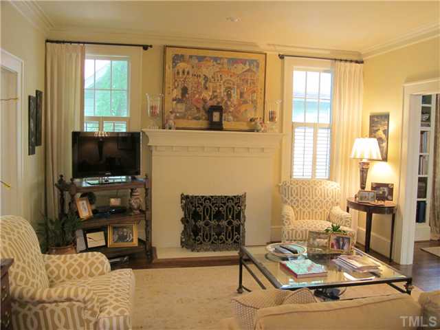 2238 The Circle Raleigh, NC 27608 - Photo 6 of 23 a living room with furniture a flat screen tv and a floor to ceiling window
