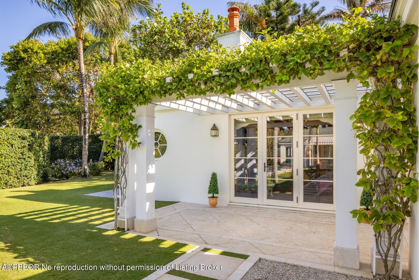 710 South County Road Palm Beach, FL 33480 - Photo 46 of 69 a front view of a house with a yard