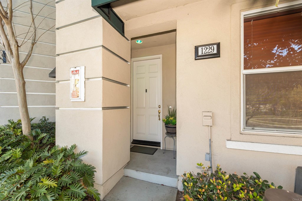 a view of a front door and wooden floor