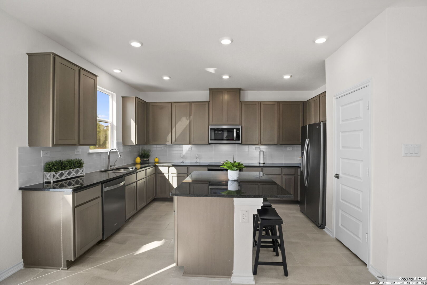 14839 Vance Jackson Road, Unit 508 San Antonio, TX 78249 - Photo 11 of 35 a kitchen with stainless steel appliances granite countertop a refrigerator and a stove top oven