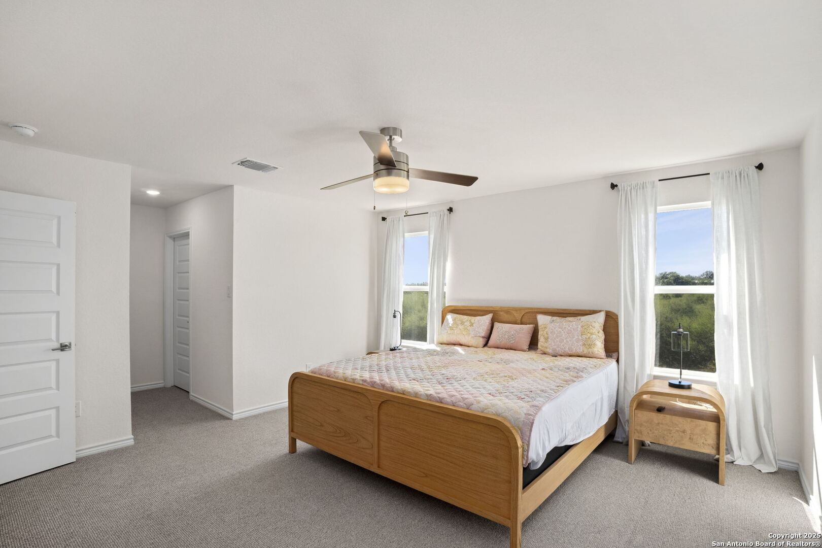 14839 Vance Jackson Road, Unit 508 San Antonio, TX 78249 - Photo 16 of 35 a bedroom with a bed and a chandelier