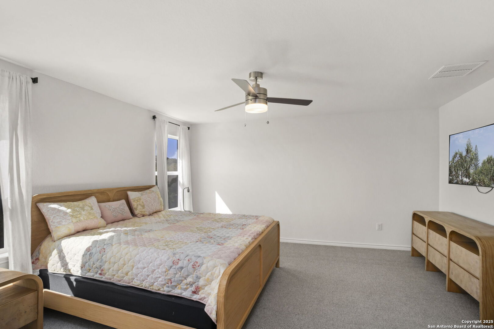 14839 Vance Jackson Road, Unit 508 San Antonio, TX 78249 - Photo 18 of 35 a bedroom with a bed and a chandelier