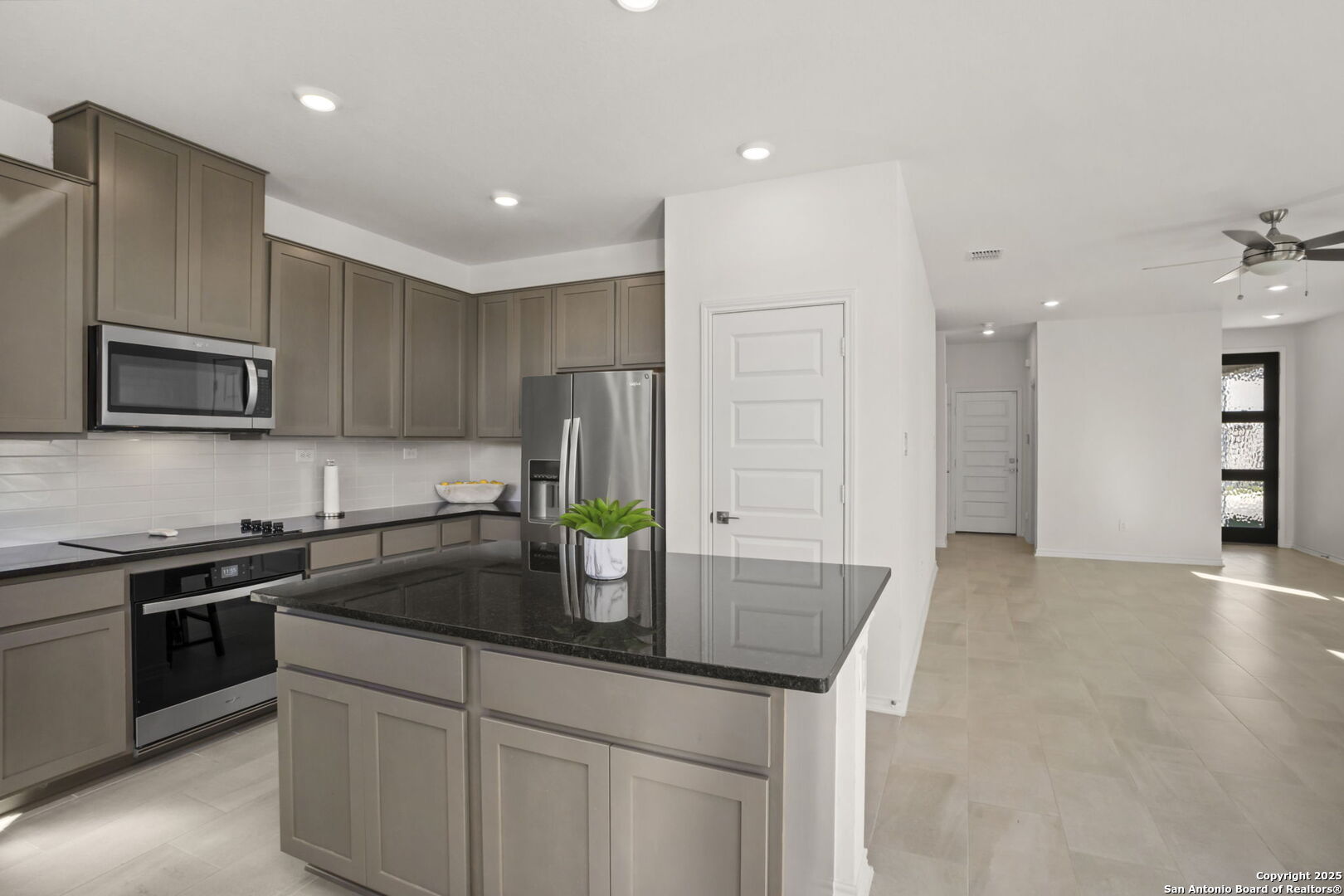 14839 Vance Jackson Road, Unit 508 San Antonio, TX 78249 - Photo 19 of 35 a kitchen with kitchen island granite countertop a sink and stainless steel appliances