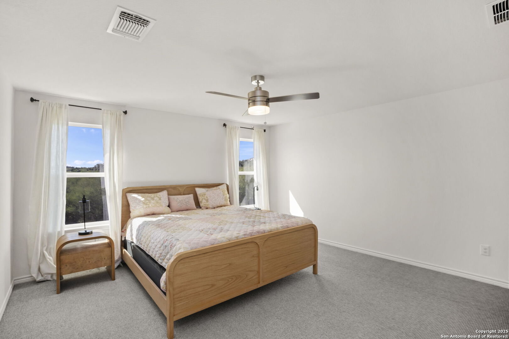 14839 Vance Jackson Road, Unit 508 San Antonio, TX 78249 - Photo 26 of 35 a bedroom with a bed and a chandelier