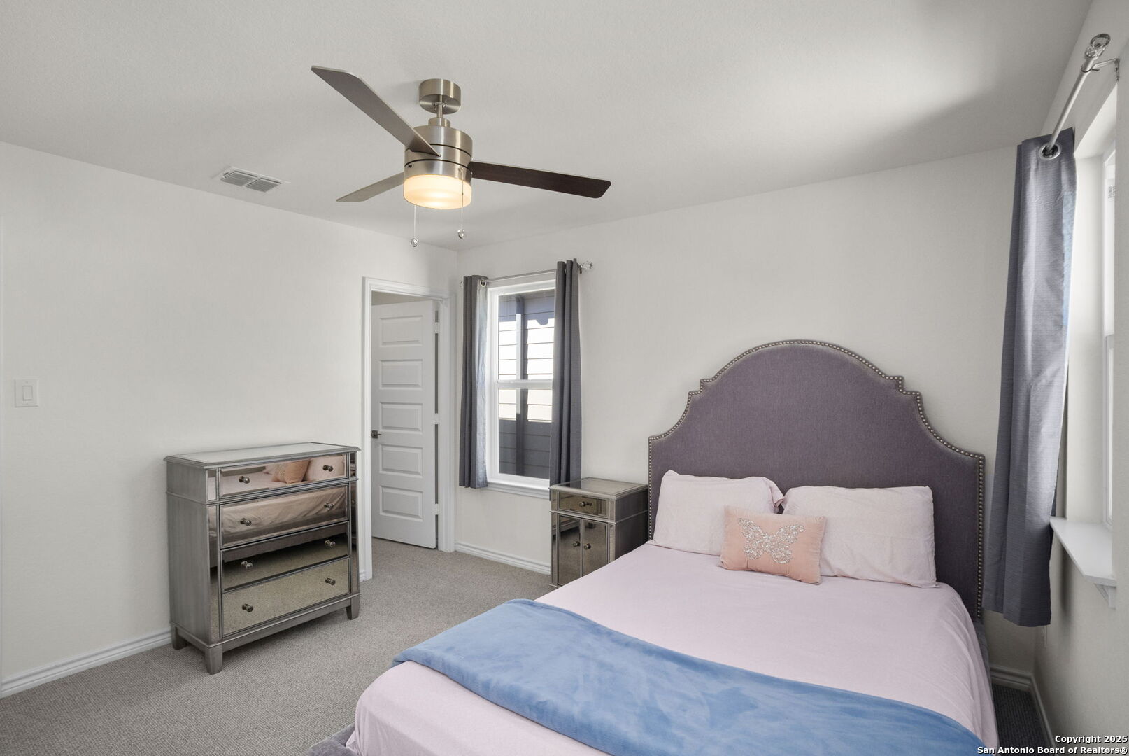 14839 Vance Jackson Road, Unit 508 San Antonio, TX 78249 - Photo 29 of 35 a bedroom with a bed and a chandelier