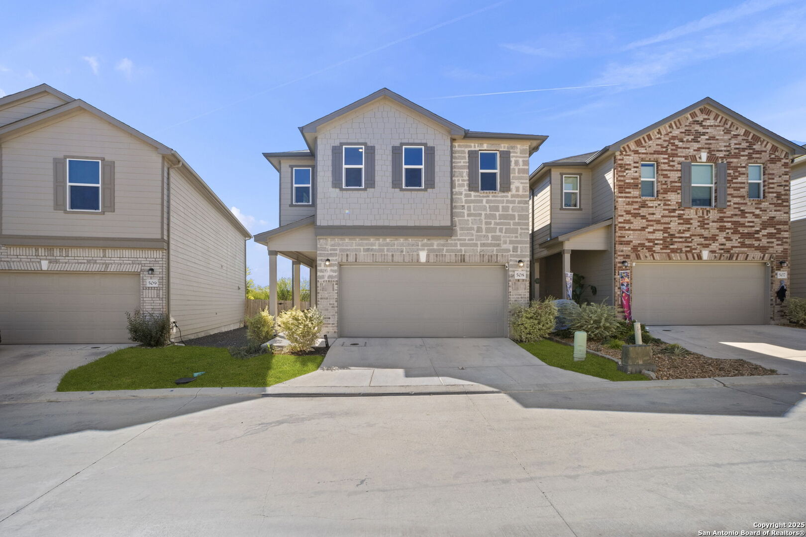 14839 Vance Jackson Road, Unit 508 San Antonio, TX 78249 - Photo 3 of 35 a front view of a house with a yard and garage