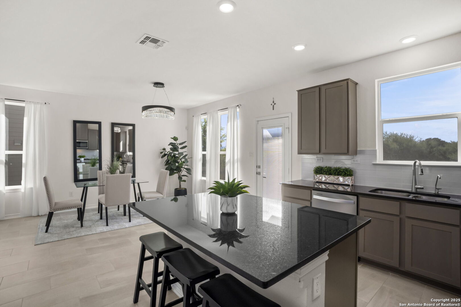 14839 Vance Jackson Road, Unit 508 San Antonio, TX 78249 - Photo 9 of 35 a kitchen with a sink and chairs