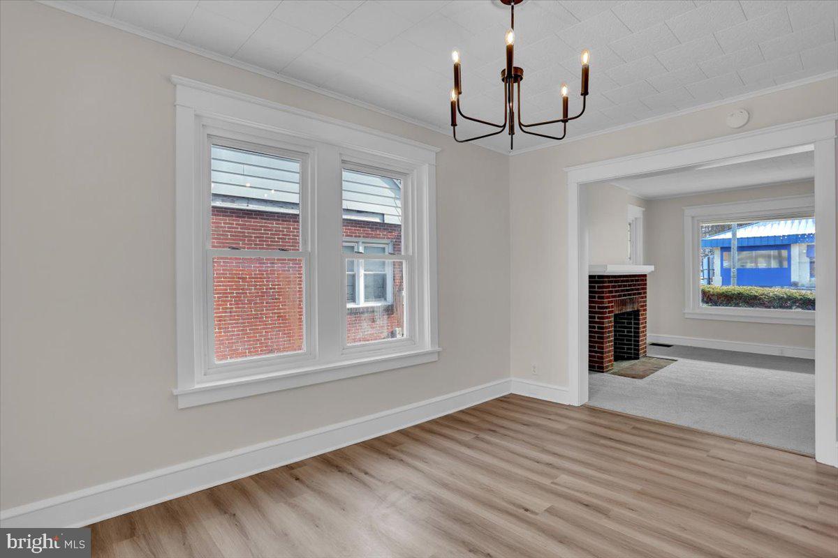 2715 Perkiomen Avenue Reading, PA 19606 - Photo 12 of 23 a view of empty room with wooden floor fireplace and windows
