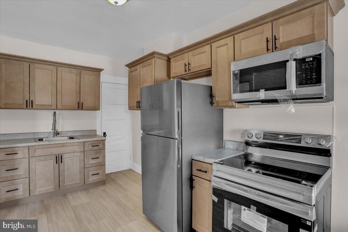2715 Perkiomen Avenue Reading, PA 19606 - Photo 13 of 23 a kitchen with stainless steel appliances a stove microwave and refrigerator