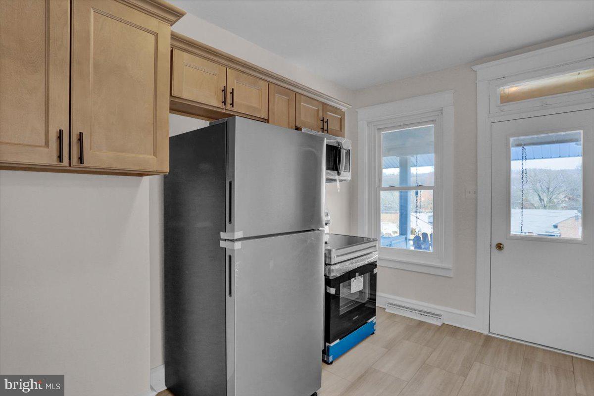 2715 Perkiomen Avenue Reading, PA 19606 - Photo 15 of 23 a white refrigerator freezer and a stove sitting inside of a kitchen