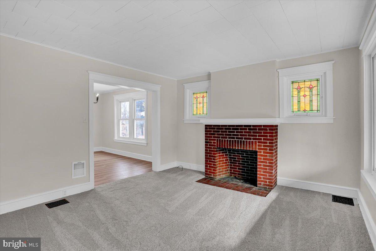 2715 Perkiomen Avenue Reading, PA 19606 - Photo 8 of 23 an empty room with windows and fireplace