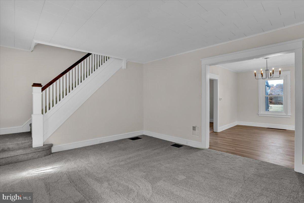2715 Perkiomen Avenue Reading, PA 19606 - Photo 10 of 23 a view of an empty room with wooden floor and stairs