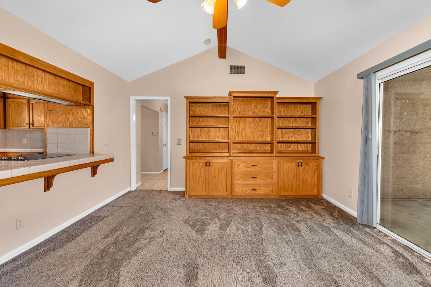 2352 Frederick Way Madera, CA 93637 - Photo 11 of 39 a view of a kitchen with wooden cabinet and a stove top oven