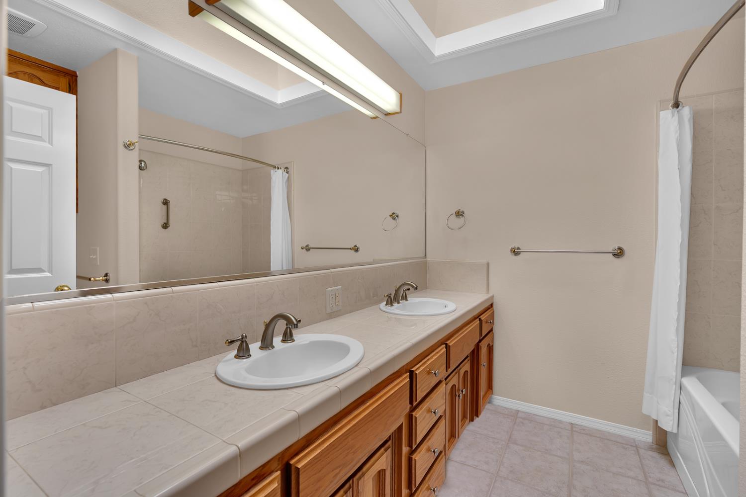 2352 Frederick Way Madera, CA 93637 - Photo 13 of 39 a bathroom with a sink and a mirror