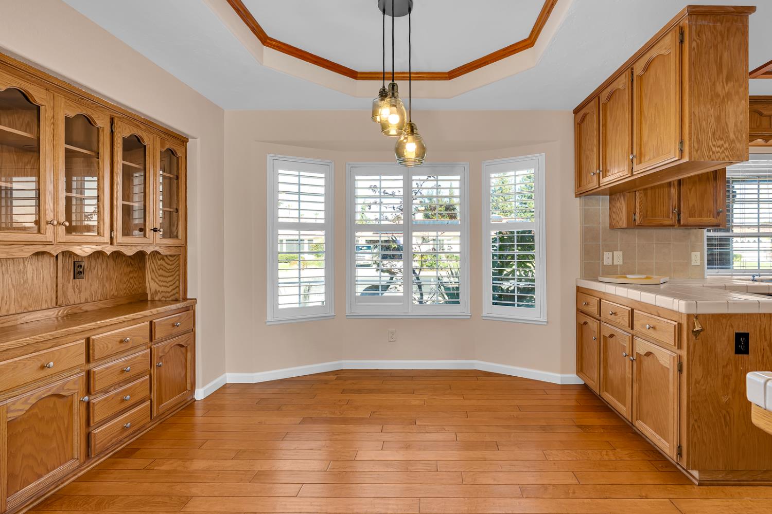 2352 Frederick Way Madera, CA 93637 - Photo 25 of 39 a kitchen with granite countertop a stove a sink and dishwasher cabinets with wooden floor