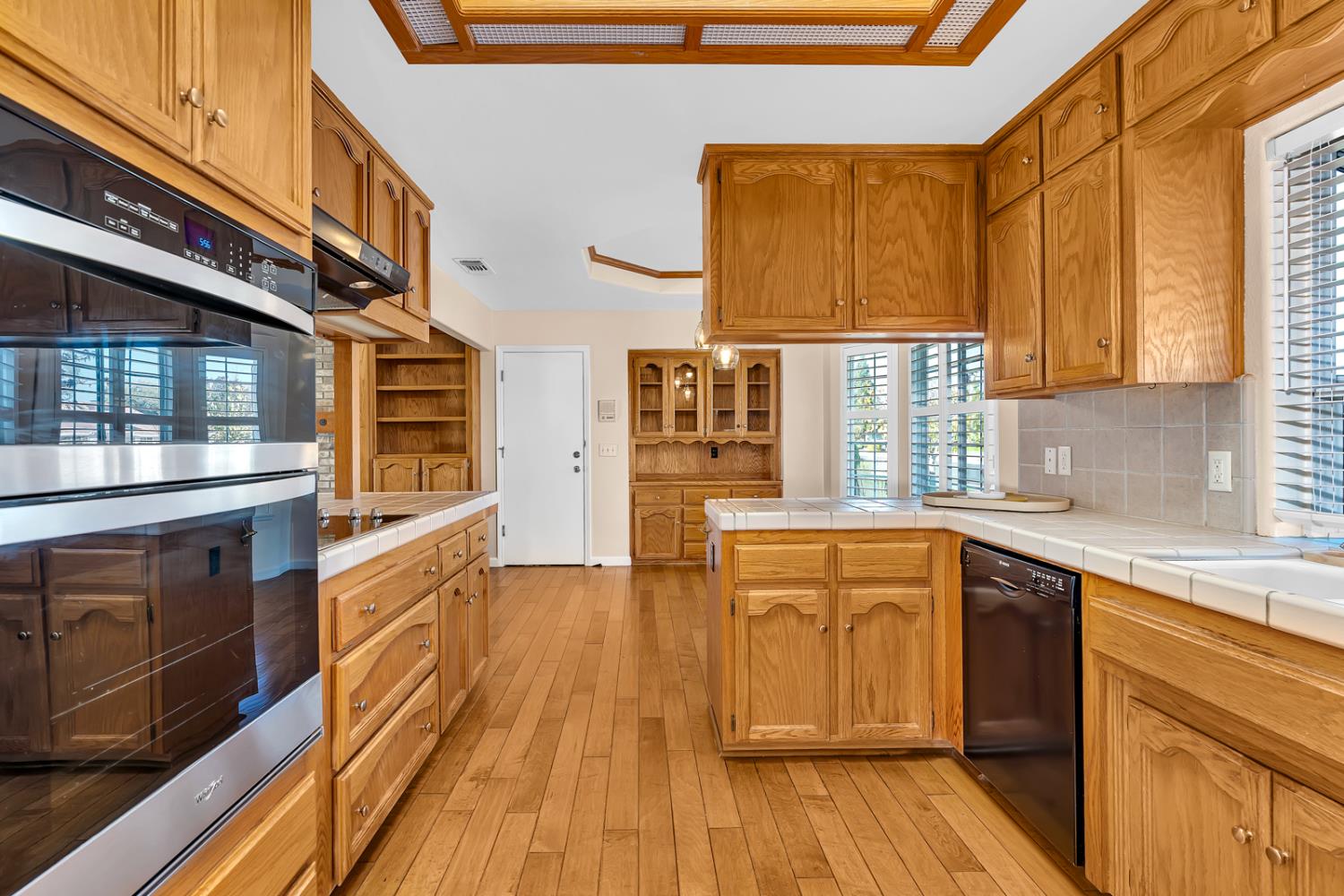 2352 Frederick Way Madera, CA 93637 - Photo 30 of 39 a kitchen with stainless steel appliances wooden floor a stove and a sink