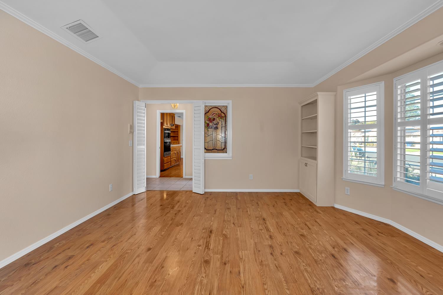 2352 Frederick Way Madera, CA 93637 - Photo 7 of 39 a view of an empty room with wooden floor and a window