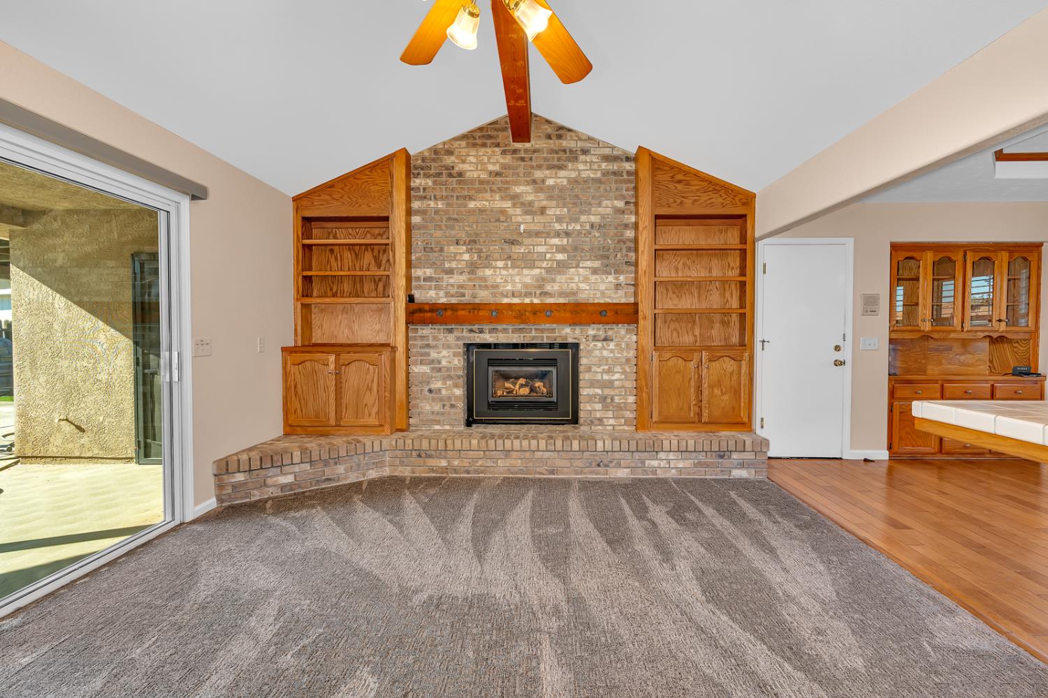 2352 Frederick Way Madera, CA 93637 - Photo 9 of 39 a view of empty room with wooden floor and fireplace