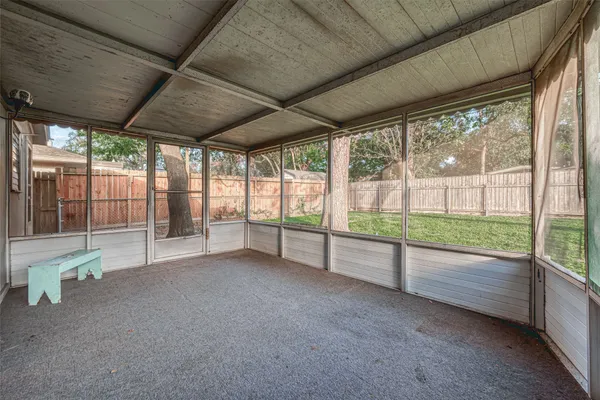 a view of an empty room with wooden floor and a porch