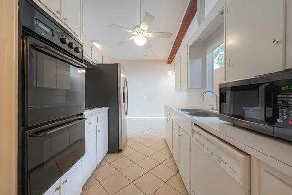 a kitchen with stainless steel appliances a stove a microwave and a refrigerator