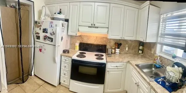 a kitchen with stainless steel appliances a stove a refrigerator and cabinets