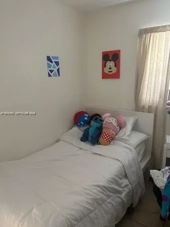 a bedroom with a bed and a painting on the wall