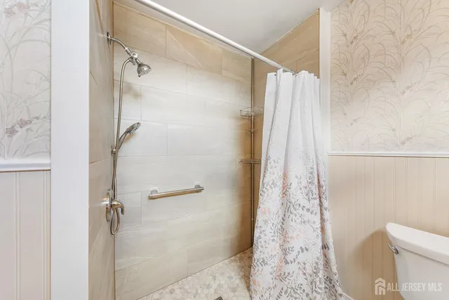 a bathroom with a shower and a toilet