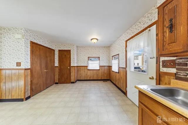 a view of a kitchen with stainless steel appliances granite countertop a refrigerator and a sink