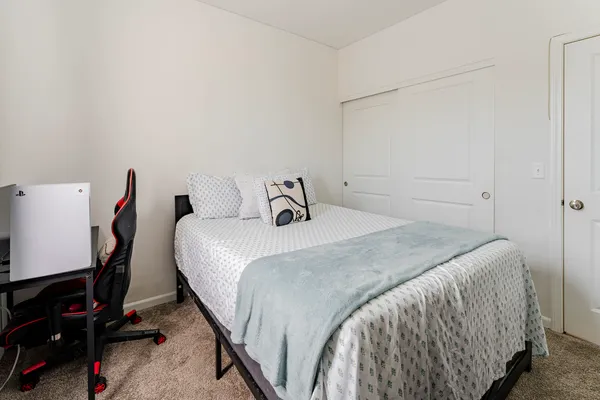 a bedroom with a bed and a closet