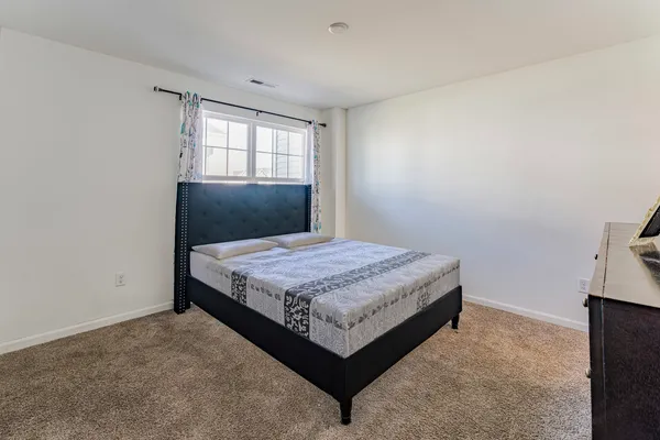 a bedroom with a bed and window