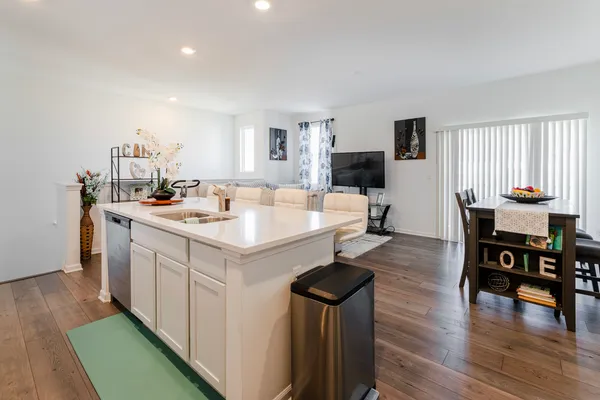a kitchen with a sink and chairs