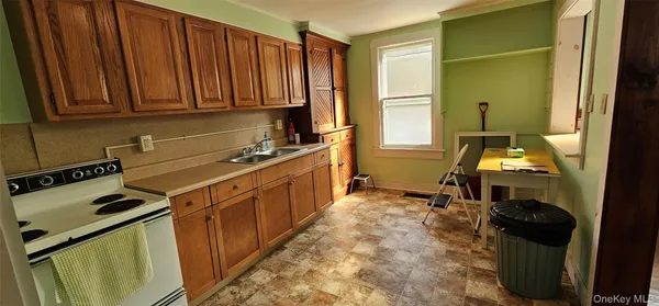 a kitchen with sink refrigerator and window