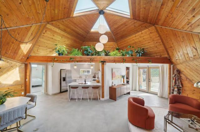 a living room with furniture and a floor to ceiling window