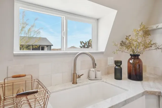 a view of a bathroom with a sink and a mirror