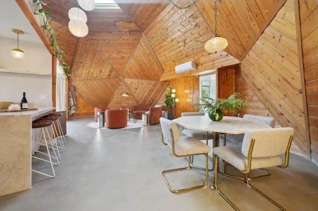 a dining room with furniture and wooden floor