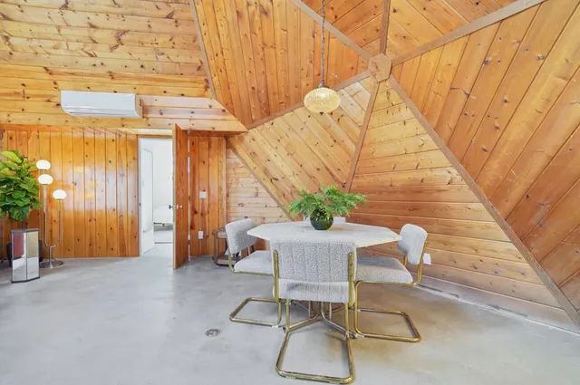 a view of a room with furniture and wooden floor