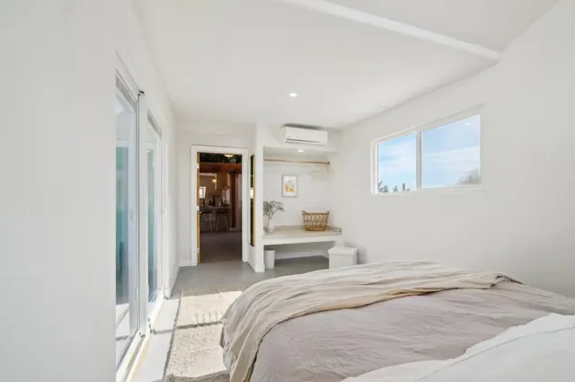 a bedroom with a bed and a view of kitchen