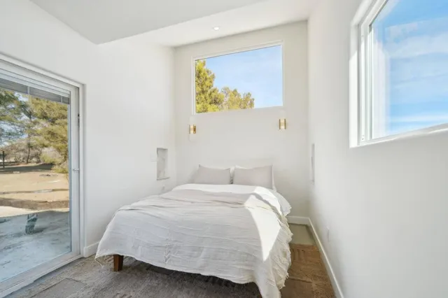 a bedroom with a bed and a window