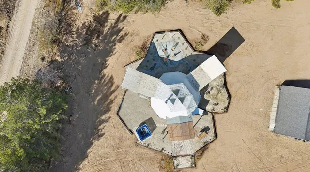 a view of a house with a yard covered in snow