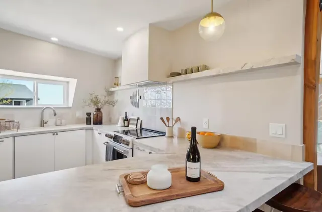 a kitchen with a sink and chairs