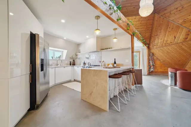 a kitchen with a table chairs refrigerator and cabinets