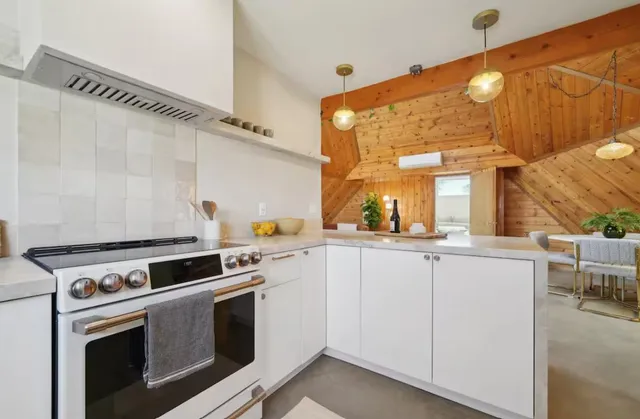 a kitchen with appliances a sink and cabinets