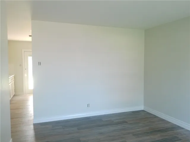 a view of an empty room and wooden floor