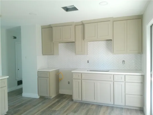 a view of cabinets with wooden floor