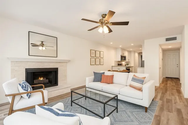 a living room with furniture and a fireplace