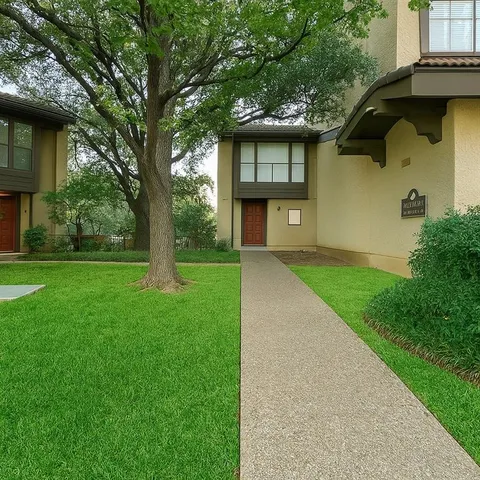 a front view of a house with a garden and trees