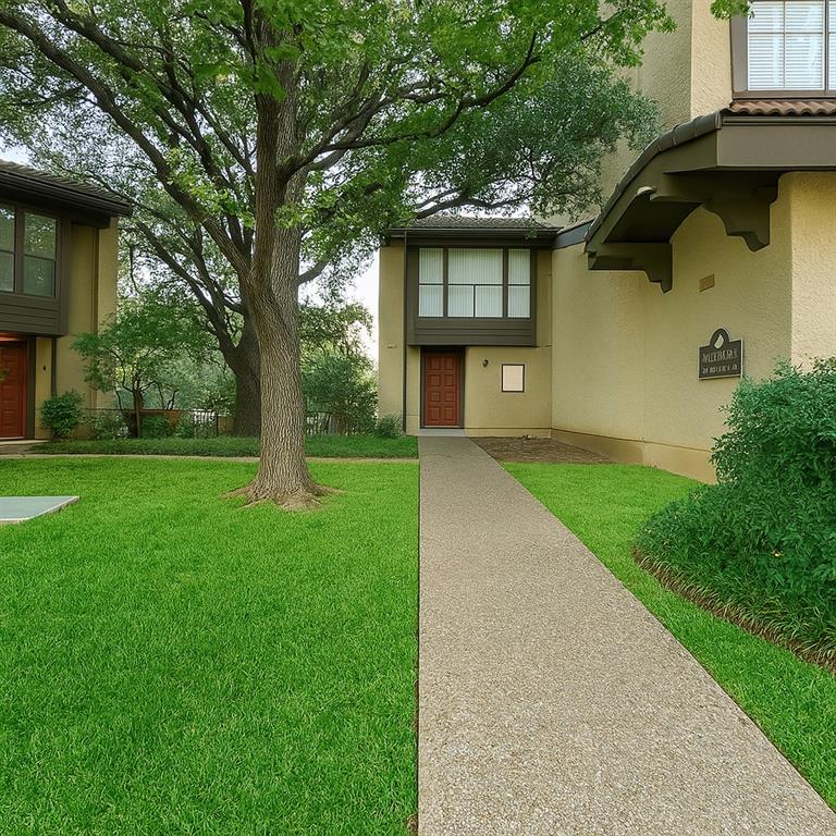 4561 O North O'Connor Road, Unit 1294 Irving, TX 75062 - Photo 14 of 31 a front view of a house with a garden and trees