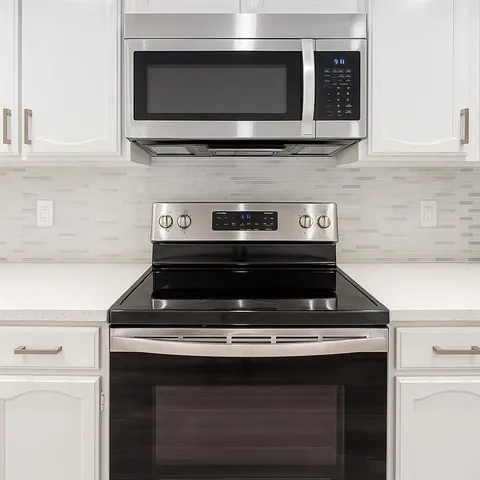a stove top oven sitting inside of a kitchen