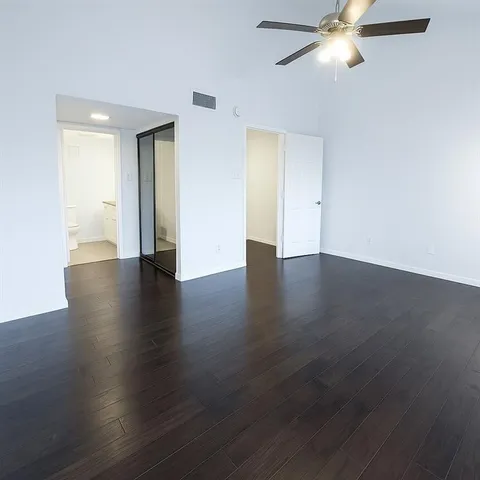 a view of a house with a wooden fence